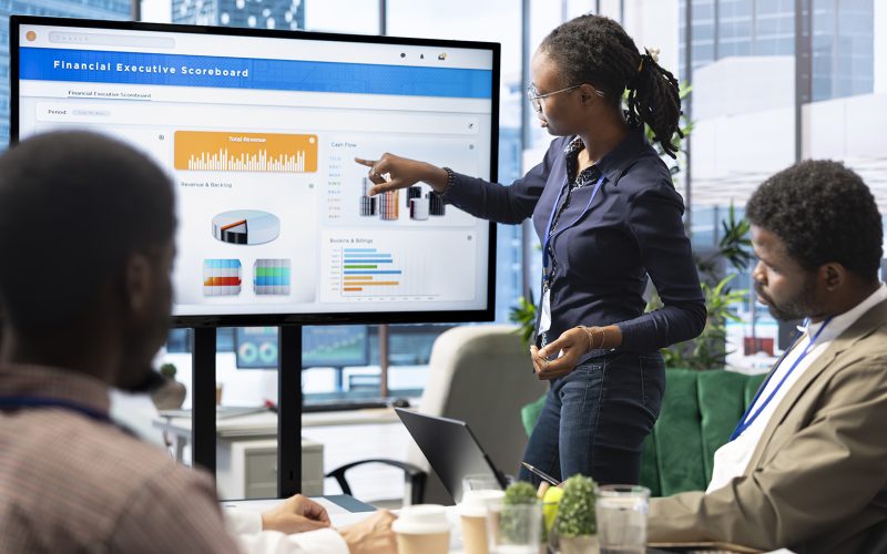 Advisory board members and team leaders gathering to review project outcomes, discuss resource allocation to ensure objectives achievement. Diverse business associates in a meeting.